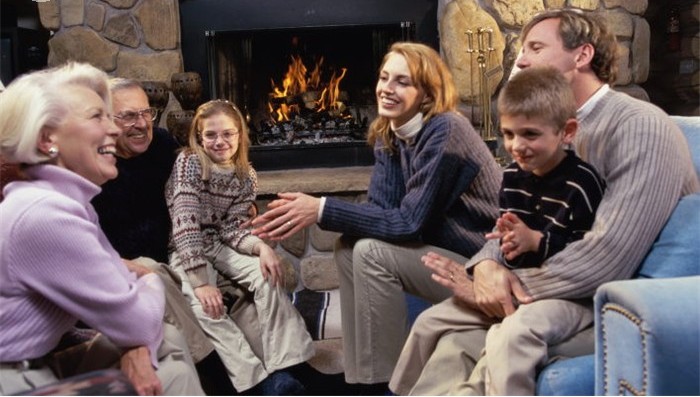 Family sitting near the fireplace in a living room