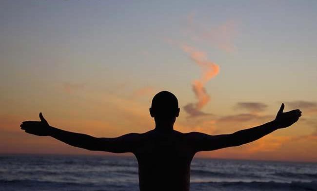Man on the beach with his arms outstretched, Santa Monica, Los Angeles County, California, USA